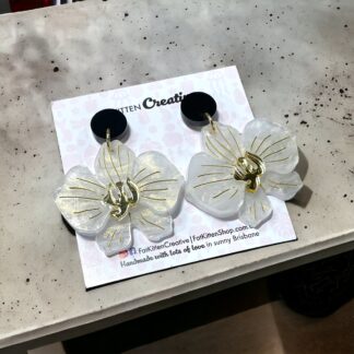 White Acrylic Orchid earrings. White acrylic with a hint of gold, gold mirror acrylic. Available with stud backed topper or hoop.