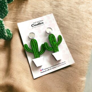 Cactus dangle earring. Green marble acrylic, etched, paintfilled. White acrylic pot, silver mirror acrylic topper. Surgical steel post.